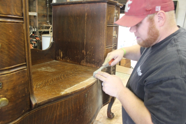 This is the Oak Vanity before restoration. Nick is carefully scraping off old finish.